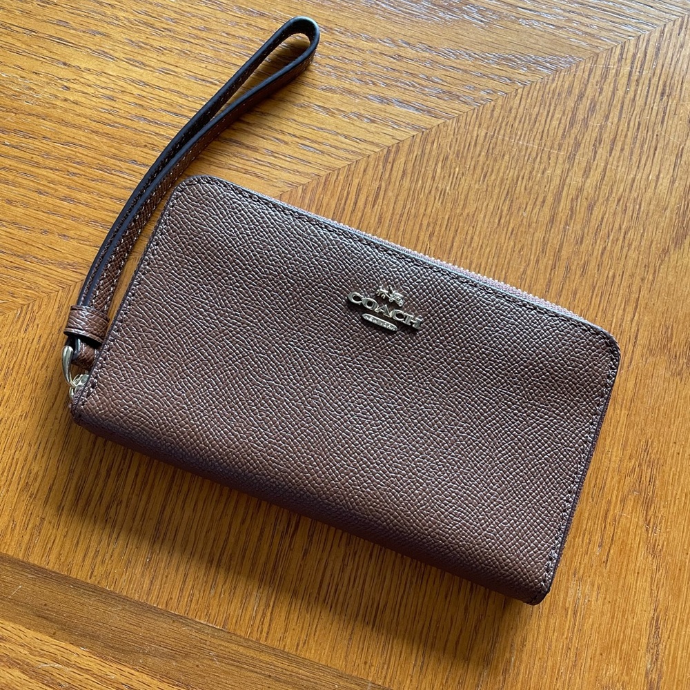 LIKE NEW! Tan coach wristlet - used only once.